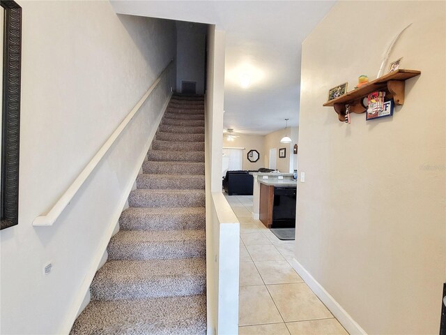 2951 SW 35th Pl Unit 148, Gainesville, FL 32608 - staircase with tile patterned flooring and baseboards