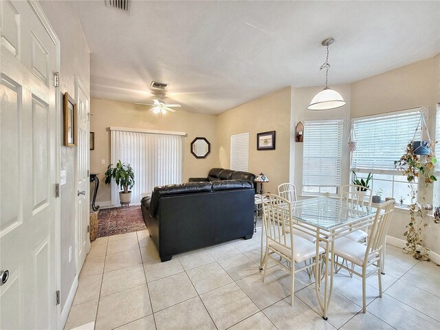 2951 SW 35th Pl Unit 148, Gainesville, FL 32608 - dining area featuring a ceiling fan, light tile patterned floors, and baseboards