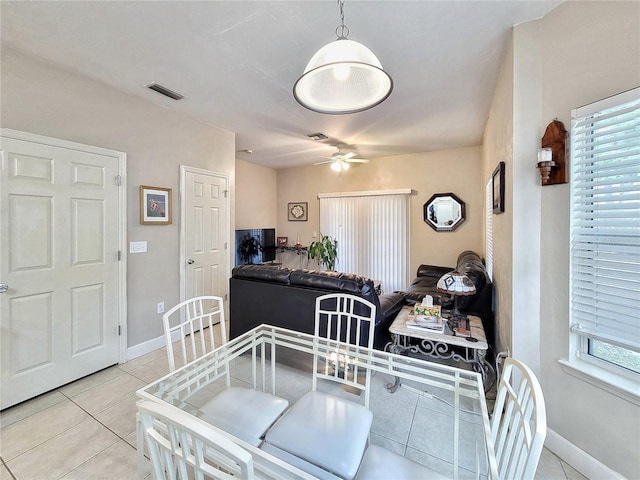 2951 SW 35th Pl Unit 148, Gainesville, FL 32608 - dining room featuring ceiling fan, baseboards, light tile patterned floors, and plenty of natural light