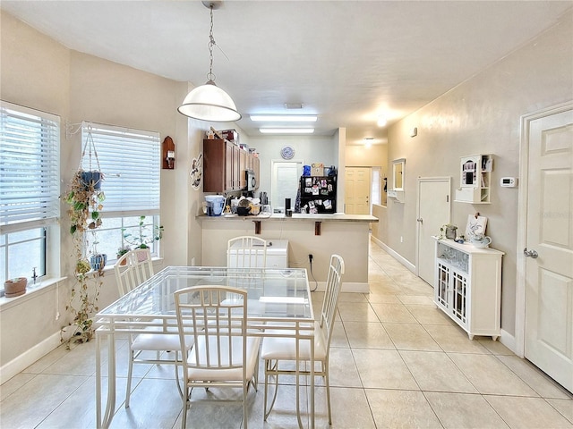 2951 SW 35th Pl Unit 148, Gainesville, FL 32608 - dining space with light tile patterned flooring and baseboards
