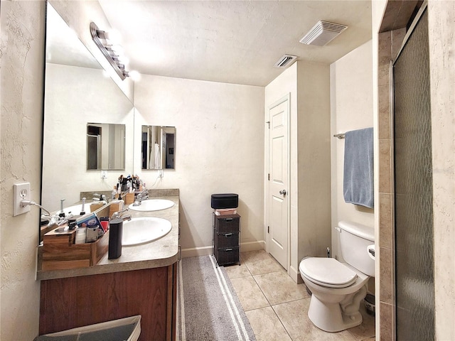 2951 SW 35th Pl Unit 148, Gainesville, FL 32608 - full bathroom with double vanity, tile patterned floors, toilet, and an enclosed shower