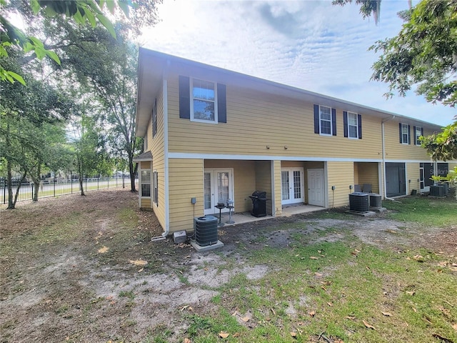 2951 SW 35th Pl Unit 148, Gainesville, FL 32608 - back of property featuring french doors, cooling unit, and a patio