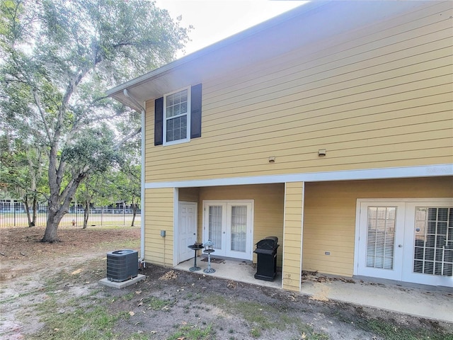 2951 SW 35th Pl Unit 148, Gainesville, FL 32608 - rear view of house with french doors and cooling unit