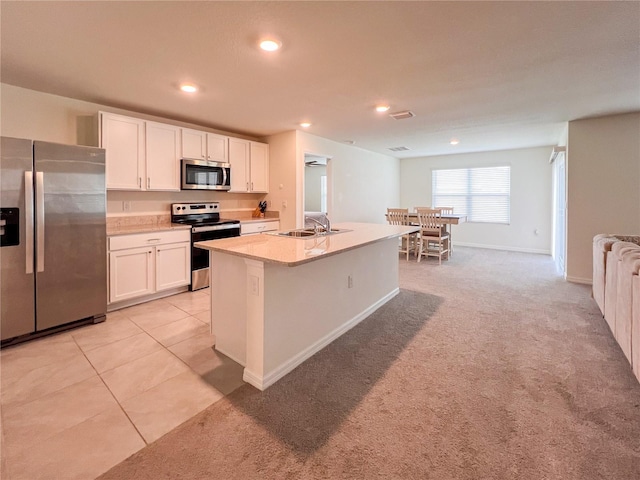 19140 NW 164th Pl, High Springs, FL 32643 - kitchen featuring appliances with stainless steel finishes, a sink, white cabinetry, light countertops, and recessed lighting