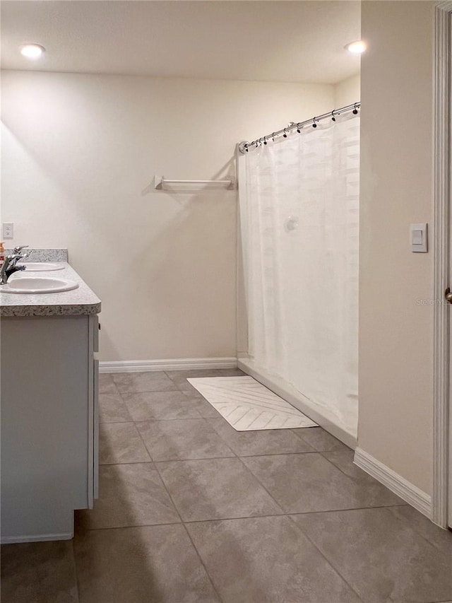 19140 NW 164th Pl, High Springs, FL 32643 - bathroom with double vanity, tile patterned floors, baseboards, recessed lighting, and curtained shower