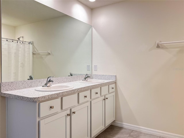 19140 NW 164th Pl, High Springs, FL 32643 - bathroom featuring double vanity, tile patterned floors, and baseboards
