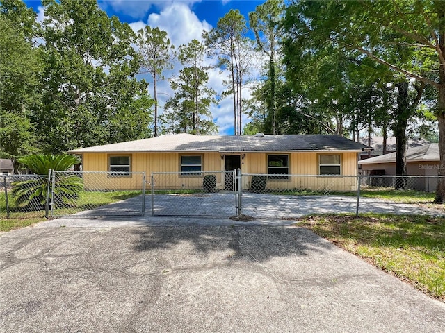6226 SW 10th Pl, Gainesville, FL 32607 - view of front facade featuring a gate, a fenced front yard, and driveway
