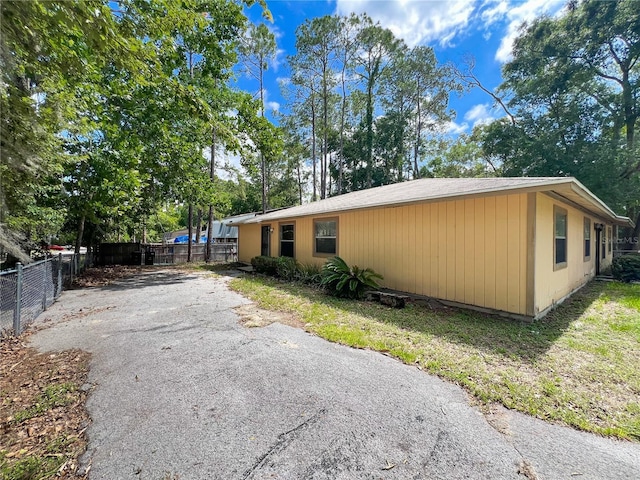 6226 SW 10th Pl, Gainesville, FL 32607 - view of side of home featuring view of wooded area and driveway