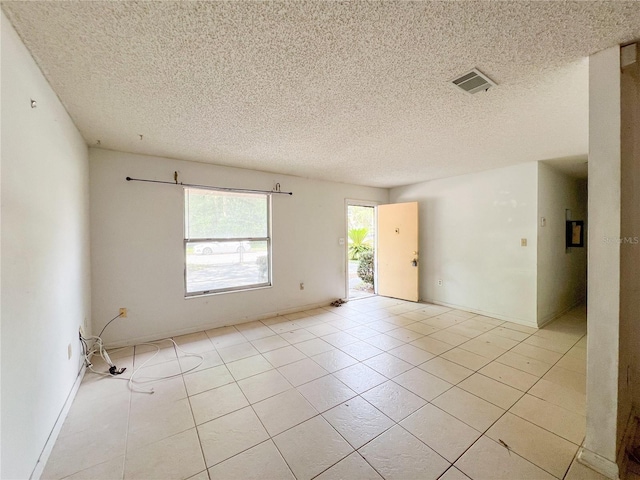 6226 SW 10th Pl, Gainesville, FL 32607 - unfurnished room with a textured ceiling, light tile patterned flooring, and baseboards