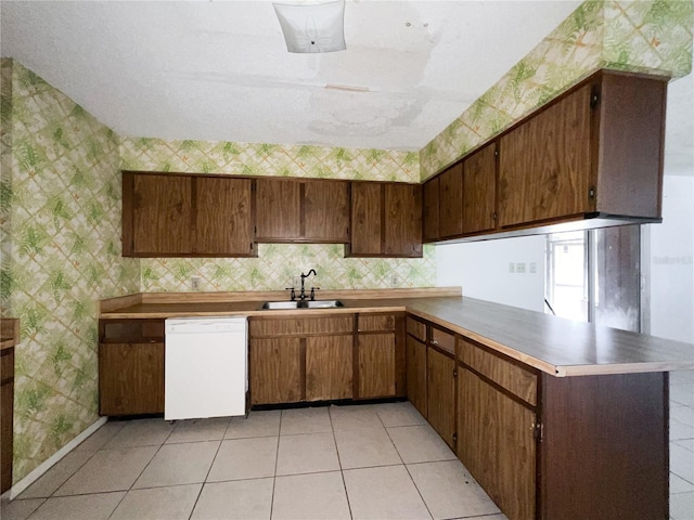 6226 SW 10th Pl, Gainesville, FL 32607 - kitchen with dishwasher, a sink, wallpapered walls, a peninsula, and light tile patterned flooring
