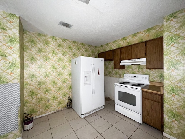 6226 SW 10th Pl, Gainesville, FL 32607 - kitchen featuring white appliances, under cabinet range hood, wallpapered walls, a textured ceiling, and light tile patterned flooring