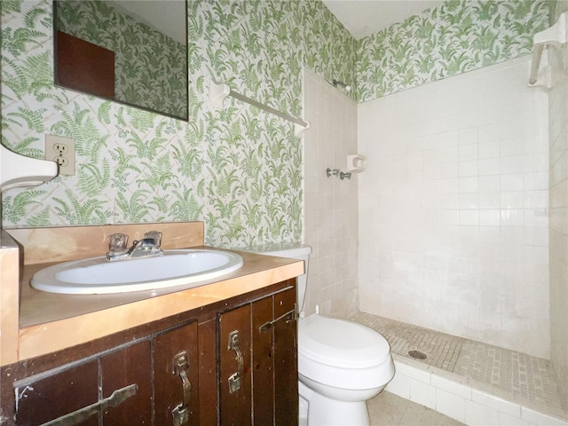 6226 SW 10th Pl, Gainesville, FL 32607 - bathroom featuring wallpapered walls, vanity, tiled shower, and toilet