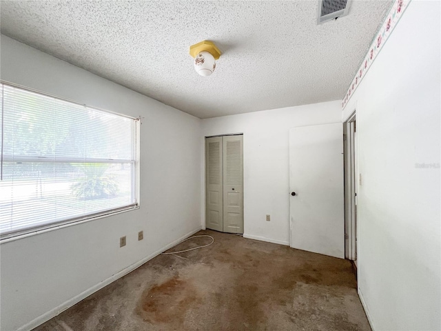 6226 SW 10th Pl, Gainesville, FL 32607 - unfurnished bedroom featuring carpet, a textured ceiling, a closet, and baseboards