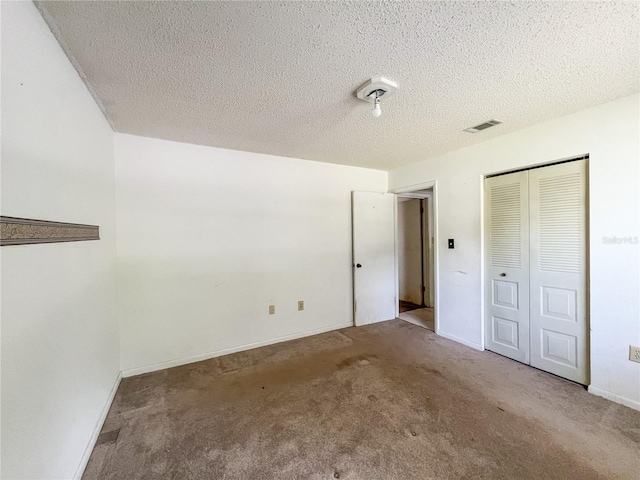 6226 SW 10th Pl, Gainesville, FL 32607 - unfurnished bedroom with carpet flooring, a closet, a textured ceiling, and baseboards
