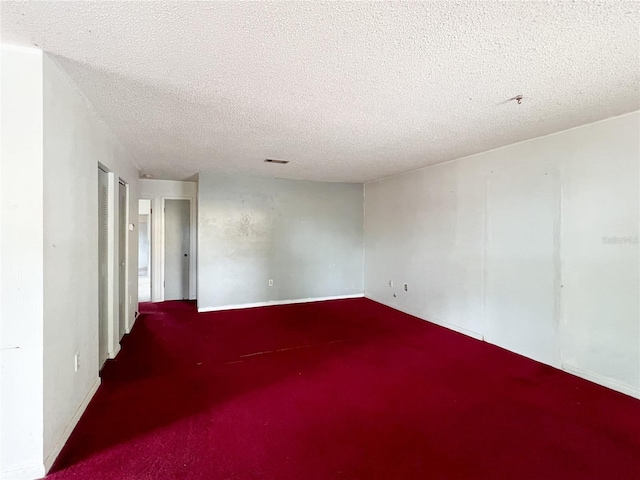 6226 SW 10th Pl, Gainesville, FL 32607 - unfurnished room featuring a textured ceiling, carpet, and baseboards