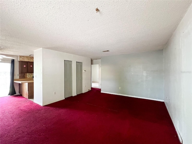 6226 SW 10th Pl, Gainesville, FL 32607 - spare room with carpet floors, a textured ceiling, and baseboards