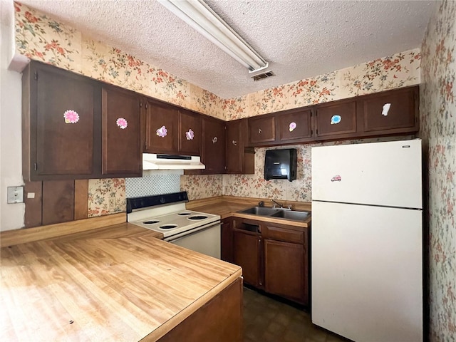 6226 SW 10th Pl, Gainesville, FL 32607 - kitchen featuring white appliances, wallpapered walls, a sink, under cabinet range hood, and dark brown cabinets