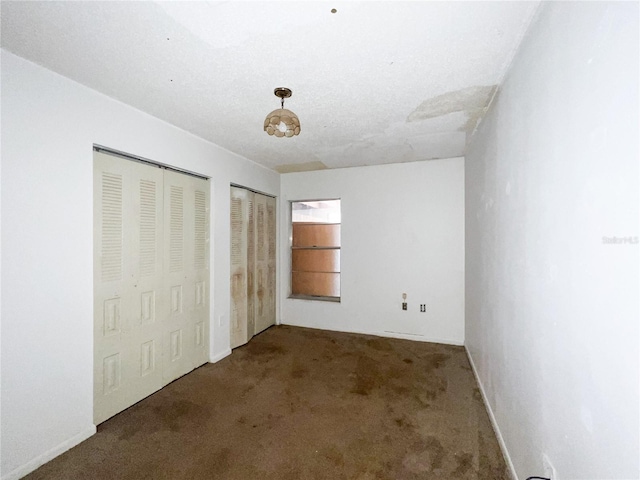 6226 SW 10th Pl, Gainesville, FL 32607 - unfurnished bedroom featuring two closets and carpet flooring