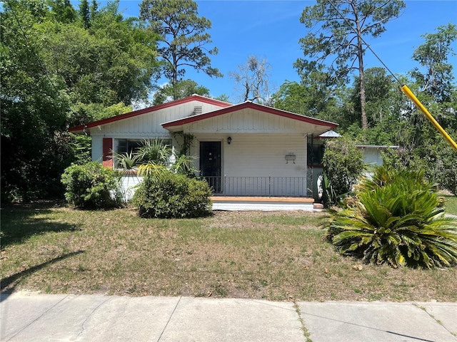 1212 NE 5th Ter, Gainesville, FL 32601 - view of front of house featuring a porch and a front yard