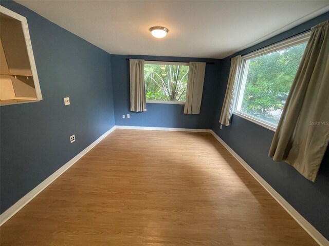 3008 NE 11th Dr, Gainesville, FL 32609 - empty room with wood finished floors and baseboards