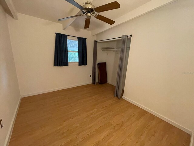 3008 NE 11th Dr, Gainesville, FL 32609 - unfurnished bedroom featuring light wood finished floors, baseboards, a closet, vaulted ceiling, and ceiling fan