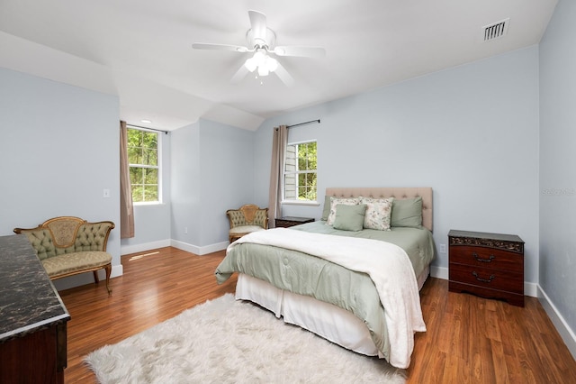1412 SW 98th St, Gainesville, FL 32607 - bedroom with wood finished floors, baseboards, and multiple windows