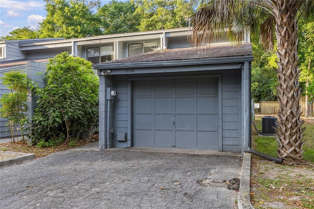 3026 NW 28th Cir, Gainesville, FL 32605 - garage with central AC unit and asphalt driveway