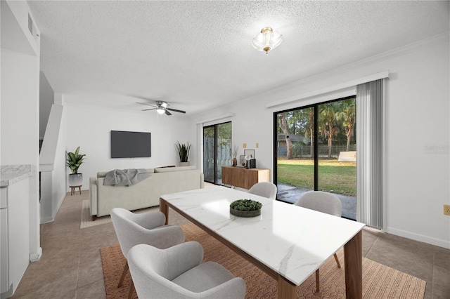 3026 NW 28th Cir, Gainesville, FL 32605 - dining space featuring light tile patterned flooring, ceiling fan, a textured ceiling, and baseboards