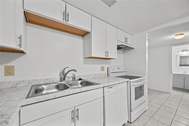 3026 NW 28th Cir, Gainesville, FL 32605 - kitchen with white appliances, a sink, light countertops, white cabinets, and a textured ceiling