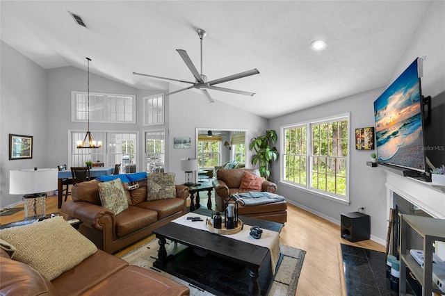 5434 SW 91st Ter, Gainesville, FL 32608 - living area with lofted ceiling, ceiling fan, baseboards, wood finished floors, and a chandelier