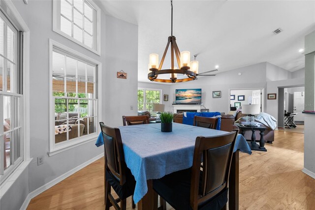5434 SW 91st Ter, Gainesville, FL 32608 - dining space featuring a chandelier, light wood-style floors, high vaulted ceiling, baseboards, and recessed lighting
