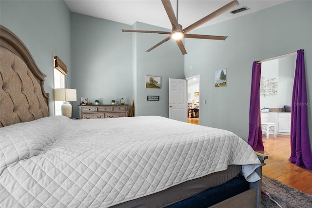 5434 SW 91st Ter, Gainesville, FL 32608 - bedroom with high vaulted ceiling, wood finished floors, a ceiling fan, and ensuite bathroom