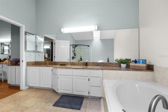 5434 SW 91st Ter, Gainesville, FL 32608 - full bathroom featuring a garden tub, vanity, a stall shower, and tile patterned floors