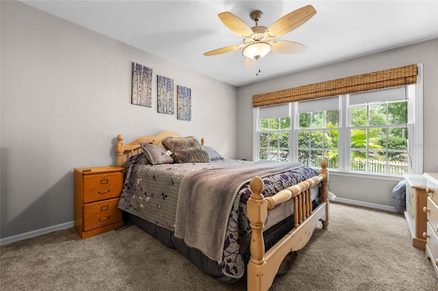 5434 SW 91st Ter, Gainesville, FL 32608 - bedroom with baseboards, carpet floors, and a ceiling fan