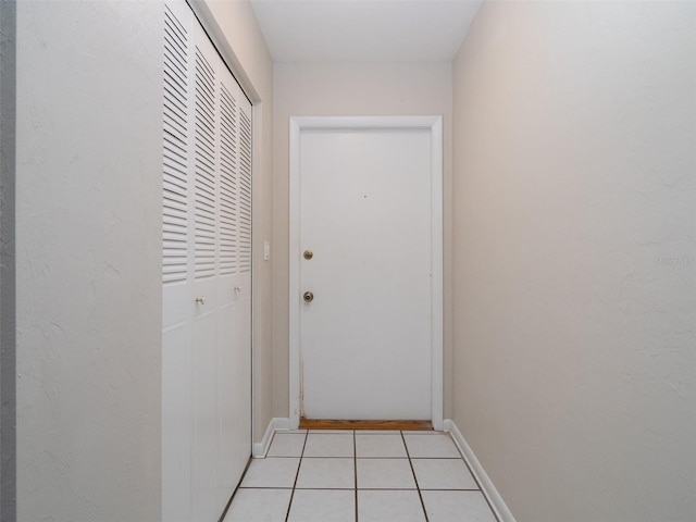 3703 NW 107th Ter, Gainesville, FL 32606 - doorway to outside with light tile patterned floors and baseboards