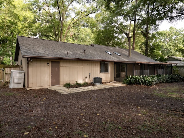 3703 NW 107th Ter, Gainesville, FL 32606 - back of property featuring a shingled roof, a sunroom, and cooling unit