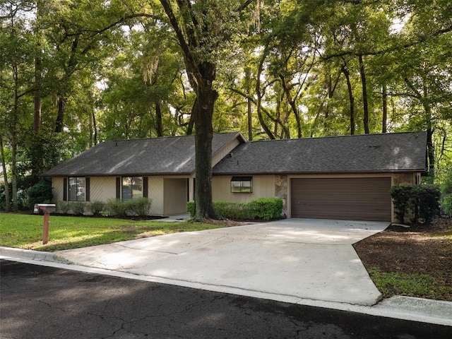 3703 NW 107th Ter, Gainesville, FL 32606 - view of front of property with a garage, concrete driveway, a front lawn, and a shingled roof