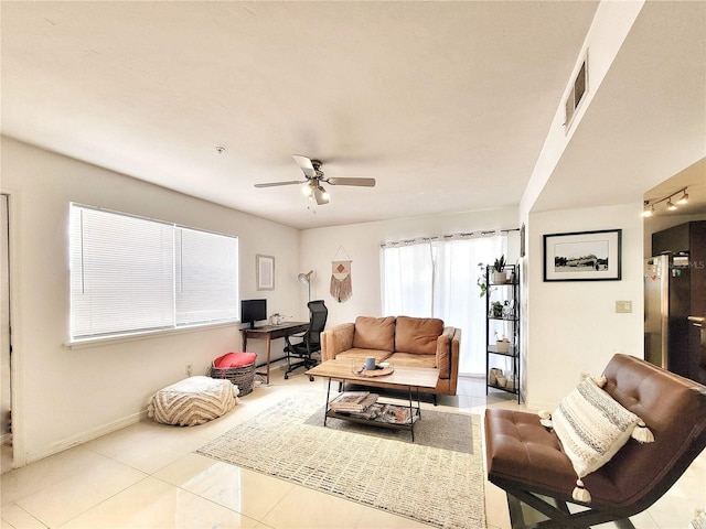 2360 SW Archer Rd Unit 101, Gainesville, FL 32608 - living area featuring a desk, a ceiling fan, tile patterned floors, and baseboards
