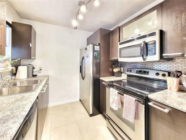 2360 SW Archer Rd Unit 101, Gainesville, FL 32608 - kitchen featuring appliances with stainless steel finishes, a sink, backsplash, and light countertops