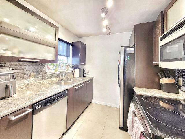 2360 SW Archer Rd Unit 101, Gainesville, FL 32608 - kitchen with appliances with stainless steel finishes, a sink, decorative backsplash, light countertops, and light tile patterned floors