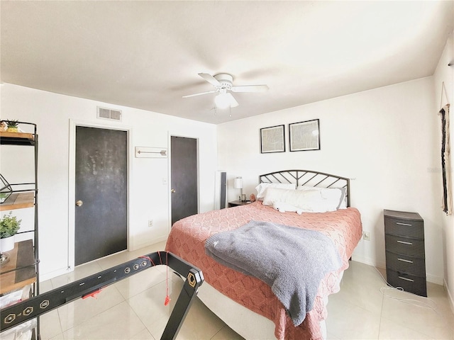 2360 SW Archer Rd Unit 101, Gainesville, FL 32608 - bedroom featuring tile patterned floors, a ceiling fan, and baseboards