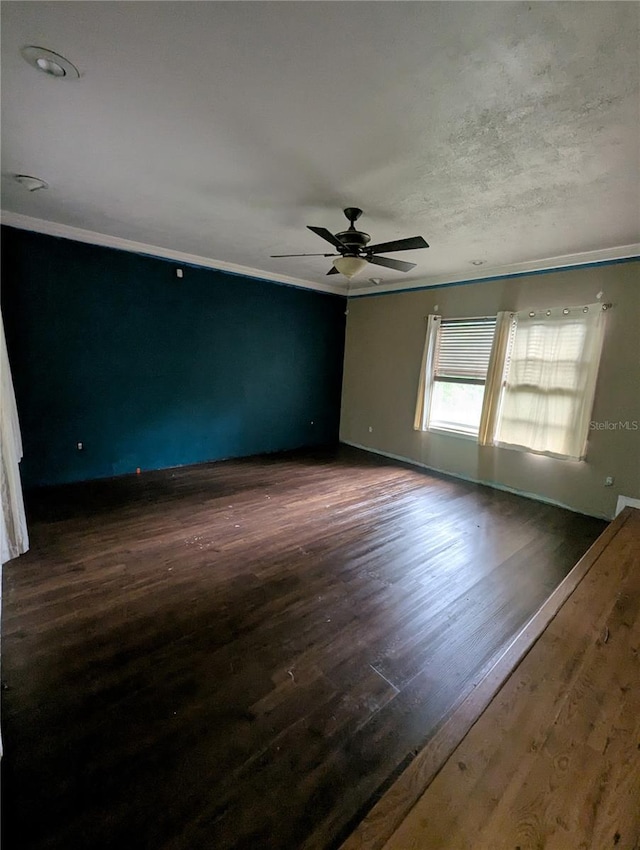 5768 SW 52nd Ter, Lake Butler, FL 32054 - spare room featuring a ceiling fan, dark wood finished floors, baseboards, and crown molding