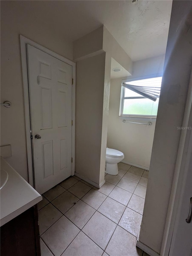 5768 SW 52nd Ter, Lake Butler, FL 32054 - bathroom with toilet, vanity, tile patterned flooring, and baseboards