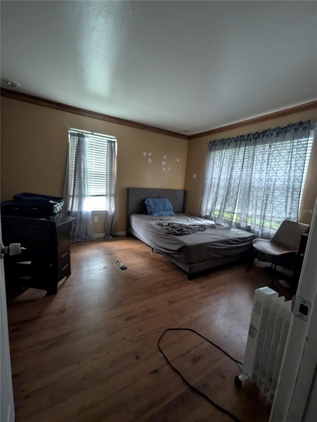 5768 SW 52nd Ter, Lake Butler, FL 32054 - bedroom with crown molding, wood finished floors, radiator, and baseboards