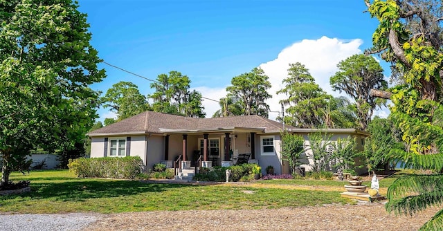18101 Boy Scout Rd, Odessa, FL 33556 - ranch-style home featuring covered porch, stucco siding, and a front yard