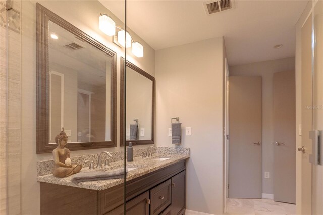 18101 Boy Scout Rd, Odessa, FL 33556 - bathroom with double vanity, marble look tiles, and baseboards