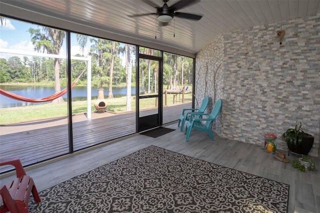 18101 Boy Scout Rd, Odessa, FL 33556 - unfurnished sunroom featuring a ceiling fan, a water view, vaulted ceiling, and view of wooded area