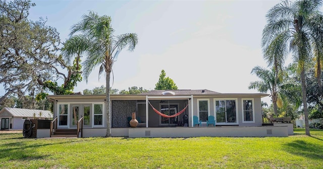 18101 Boy Scout Rd, Odessa, FL 33556 - rear view of house with a sunroom and a lawn