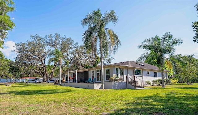 18101 Boy Scout Rd, Odessa, FL 33556 - rear view of house with a lawn and stucco siding