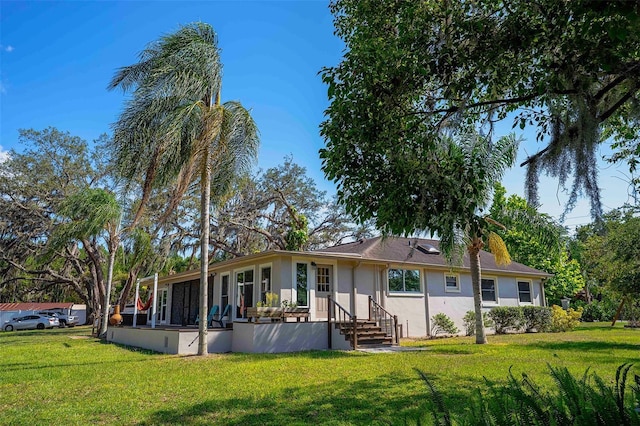 18101 Boy Scout Rd, Odessa, FL 33556 - back of property with stucco siding and a lawn